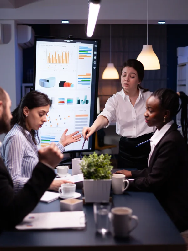 multi-ethnic-businesspeople-discussing-financial-company-solution-sitting-conference-table-meeting-room